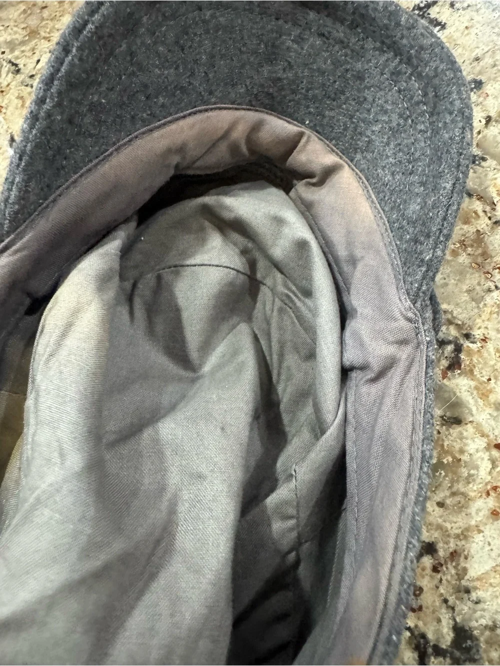 Gray newsboy cap features a felted wool blend material (CL-3)